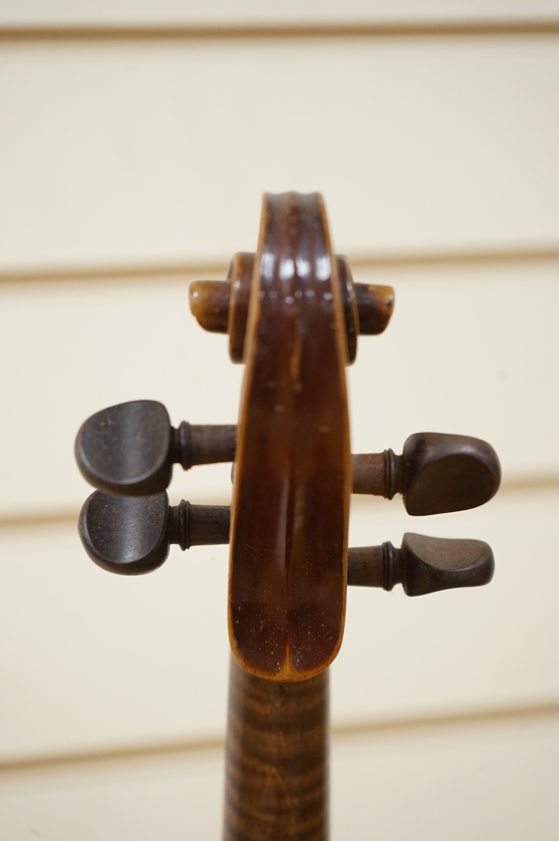 Five cased 20th century violins, including; a German violin, two Czech violins, a three-quarter size violin with a label for Bienfait, and a Romanian quarter size violin, all in cases or the remains of cases.